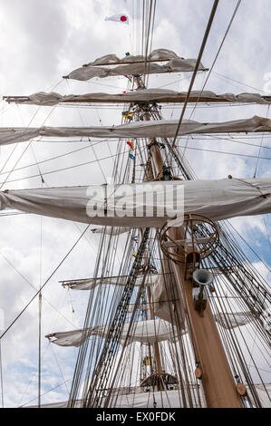 Folded sails on the mast of a sailing ship Stock Photo