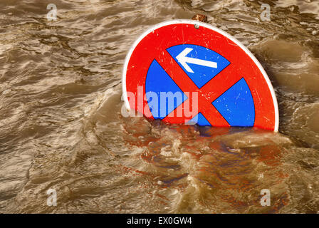 Humorous scene of a no parking traffic sign in a flood of brown water Stock Photo