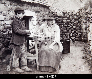 historic photographs, old Welsh woman in traditional costume with young boy outside old stone cottage Stock Photo