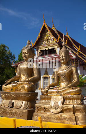 Golden Buddha statues at front yard of Wat Phra Mahathat Woramahawihan temple in Nakhon Si Thammarat, Thailand. Stock Photo
