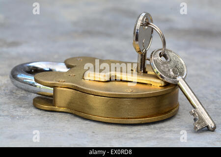 Old style lock and keys on a gray concrete background Stock Photo