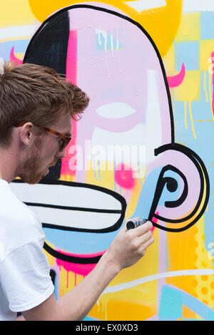 London, UK. 2 July 2015. Belgian artist Joachim creating an artwork. GraffitiStreet.com, the online street art gallery, are back for a second year to present their latest group show titled ‘Underground’ on 2 July 2015 in Shoreditch. With participating street and graffiti artists Pichi & Avo (Spain), L7m (Brazil), Bordalo II (Portugal), Hunto (Italy), Pahnl (UK), Bisser (Belgium), My Dog Sighs (UK), JPS (UK), Art is tra$h (Spain), Nils Westergard (US), Joachim (Belgium) and 3F (UK). Stock Photo