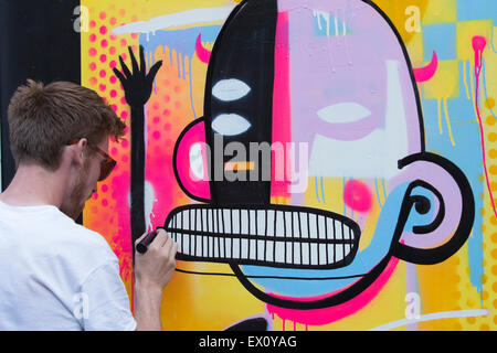 London, UK. 2 July 2015. Belgian artist Joachim creating an artwork. GraffitiStreet.com, the online street art gallery, are back for a second year to present their latest group show titled ‘Underground’ on 2 July 2015 in Shoreditch. With participating street and graffiti artists Pichi & Avo (Spain), L7m (Brazil), Bordalo II (Portugal), Hunto (Italy), Pahnl (UK), Bisser (Belgium), My Dog Sighs (UK), JPS (UK), Art is tra$h (Spain), Nils Westergard (US), Joachim (Belgium) and 3F (UK). Stock Photo