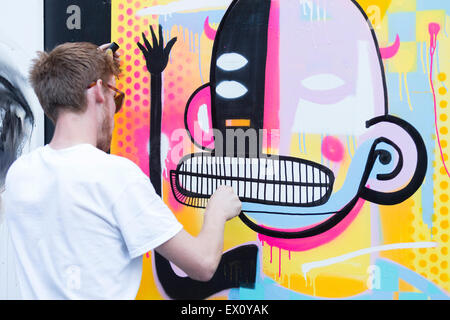 London, UK. 2 July 2015. Belgian artist Joachim creating an artwork. GraffitiStreet.com, the online street art gallery, are back for a second year to present their latest group show titled ‘Underground’ on 2 July 2015 in Shoreditch. With participating street and graffiti artists Pichi & Avo (Spain), L7m (Brazil), Bordalo II (Portugal), Hunto (Italy), Pahnl (UK), Bisser (Belgium), My Dog Sighs (UK), JPS (UK), Art is tra$h (Spain), Nils Westergard (US), Joachim (Belgium) and 3F (UK). Stock Photo