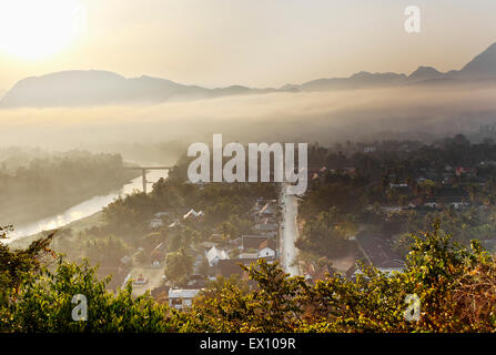 Luang Prabang at sunrise from the top of Mt. Phou Si. In the Lao language, “Phou” means mountain and “Si” means hermit. Stock Photo