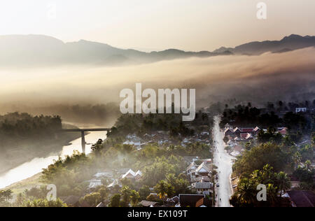Luang Prabang at sunrise from the top of Mt. Phou Si. In the Lao language, “Phou” means mountain and “Si” means hermit. Stock Photo