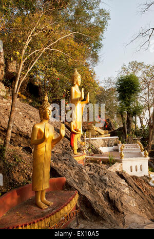 These golden statues on the Ban Khamyong side of Mt. Phou Si. depict the 7 positions of Buddha. Stock Photo