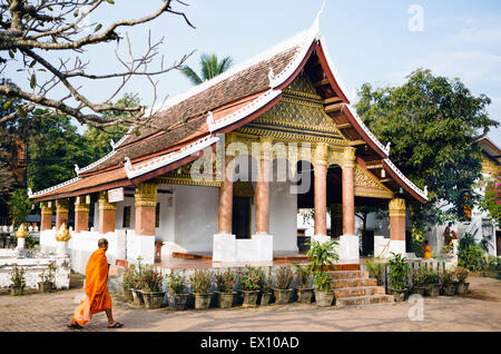 A monk walking by Vat Sop Sickharam. Luang Prabang, Laos. Stock Photo