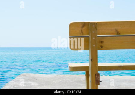 Wooden bench with the look at blue sea horizon Stock Photo