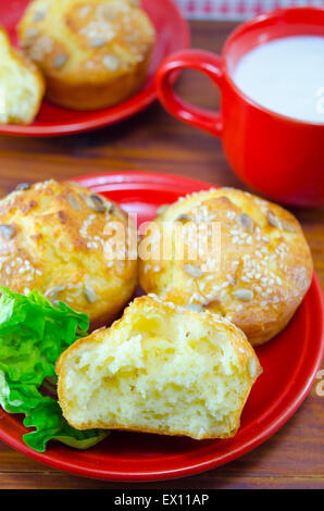 Delicious golden colored corn bread with sesame  served with yogurt and green salad in  a red plate Stock Photo