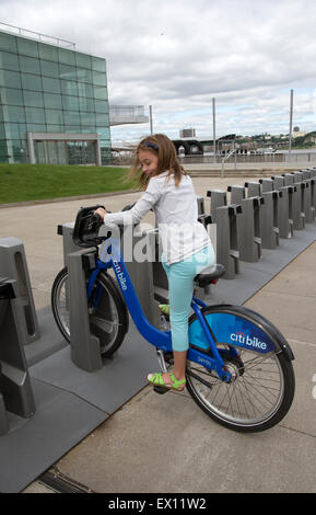 Bicycle rental station in New York USA . Child using the Citibike sponsored service in Manhattan Stock Photo