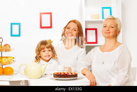 Happy family eating cake and drinking tea Stock Photo
