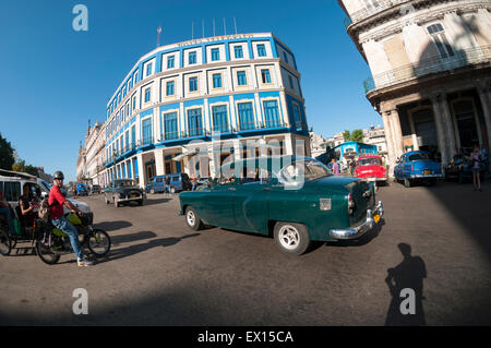 HAVANA, CUBA - JUNE, 2011: Vintage American cars drive through an intersection on the Paseo del Prado avenue in Central Havana. Stock Photo