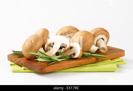 Fresh brown mushrooms on cutting board Stock Photo