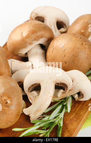 Fresh cremini mushrooms on cutting board Stock Photo