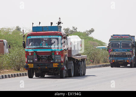Trucks on the Udaipur to Jaipur state highway. The Indian economy is heavily dependent upon the movement of goods by road Stock Photo