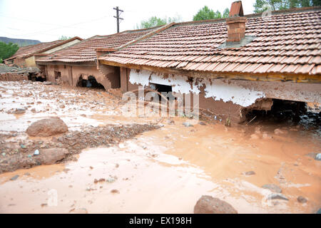 Sunan, China's Gansu Province. 4th July, 2015. Mudslide hits residential buildings in Sunan County, northwest China's Gansu Province, July 4, 2015. A heavy rainfall caused landslide in Sunan on Saturday, damaging 63 houses. Credit:  Wu Xuefeng/Xinhua/Alamy Live News Stock Photo