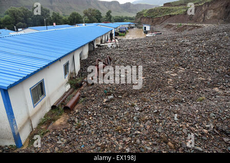 Sunan, China's Gansu Province. 4th July, 2015. Landslide damages a factory in Sunan County, northwest China's Gansu Province, July 4, 2015. A heavy rainfall caused landslide in Sunan on Saturday, damaging 63 houses. Credit:  Wu Xuefeng/Xinhua/Alamy Live News Stock Photo
