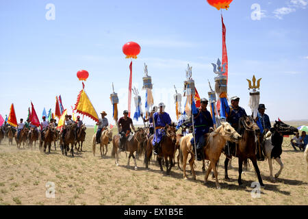 Bayan Nur, China's Inner Mongolia Autonomous Region. 4th July, 2015. People attend a Nadam fair in Urat Middle Banner, north China's Inner Mongolia Autonomous Region, July 4, 2015. Nadam is a mass traditional Mongolian festival where people celebrate harvests and pray for good luck. Credit:  Zhi Maosheng/Xinhua/Alamy Live News Stock Photo