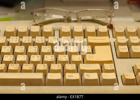 old keyboard and old spectacles Stock Photo