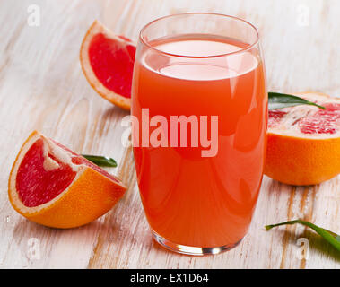 Fresh grapefruit juice  on a white wooden table. Selective focus Stock Photo
