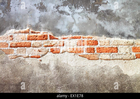 Old decayed wall of red brick cement block Type background texture. Stock Photo