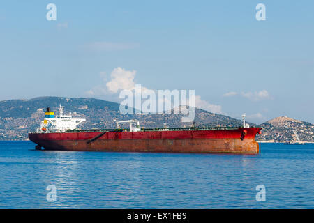 Anchored red, oil tanker near Elefsina port in Greece against a blue sky Stock Photo