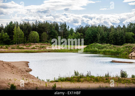 Stunning vibrant Autumn woodland reflected in still lake water landscape Stock Photo