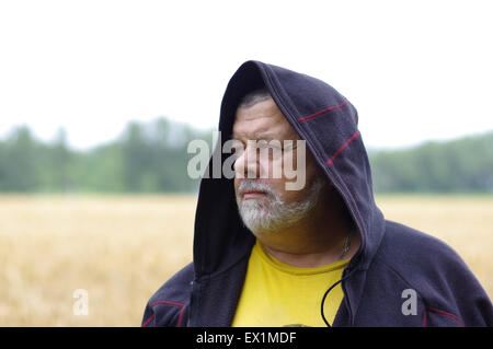 Outdoor portrait of a senior man in cowl Stock Photo