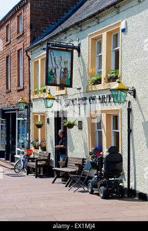 Man standing in doorway of the Shoulder of Mutton Pub, Brampton, Cumbria, England UK Stock Photo