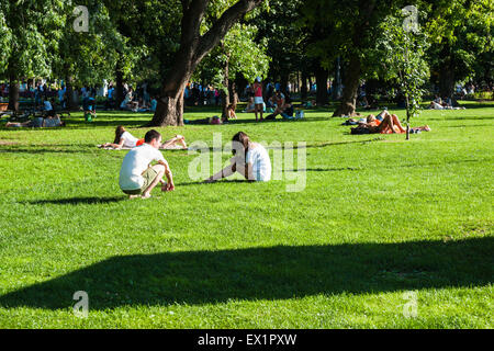 Moscow, Russia. 4th July, 2015. Hot weekend in Moscow, Russia. The temperature is about +30 degrees Centigrade (86F). This is really hot for Moscow. People prefer to spend the weekend in the country or by the water in city parks. People take the sun on a lawns of Moscow Gorky Park. Credit:  Alex's Pictures/Alamy Live News Stock Photo