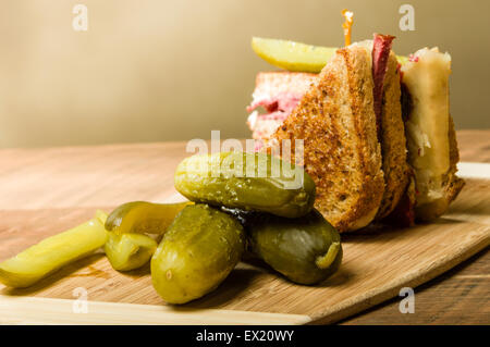 Grilled reuben sandwich with dill pickle spears Stock Photo