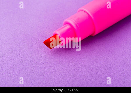 Single pink ink marker isolated on purple background Stock Photo