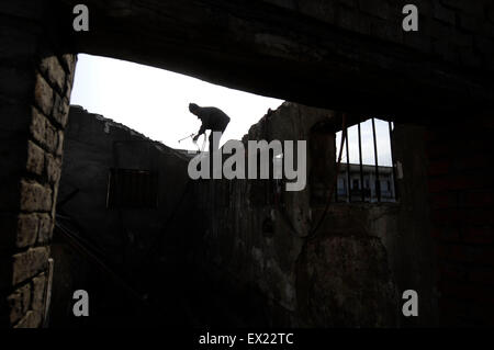 A labourer backouts an old building at a demolition site in Changzhi, Shanxi province January 29, 2010. VCP Stock Photo