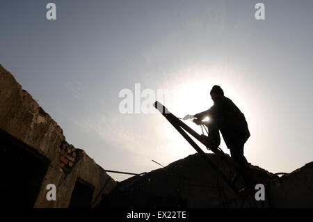 A labourer backouts an old building at a demolition site in Changzhi, Shanxi province January 29, 2010. VCP Stock Photo