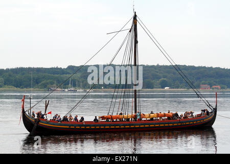 Frederikssund, Denmark, July 5, 2015. 'The Sea Stallion from Glendalough' - 'Havhingsten fra Glendalough', the 30 m long viking ship starts its summer expedition on a dull, hot, overcast, and  dead calm morning with high atmospheric humidity by being towed out of Roskilde Fjord by a motorboat. Not a great way for the largest exact reconstruction of a viking ship to start the 14 days viking expedition on northbound bearings into Kattegat. The itinerary will depend on the weather, more updated information on the Viking Ship Museum's website. Credit:  Niels Quist/Alamy Live News Stock Photo