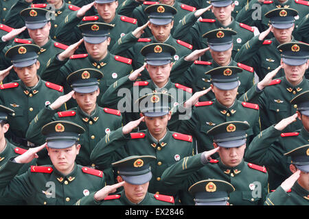 Recruits of the paramilitary police wear badges for each other on their uniforms during a rank-greated ceremony at a military ba Stock Photo