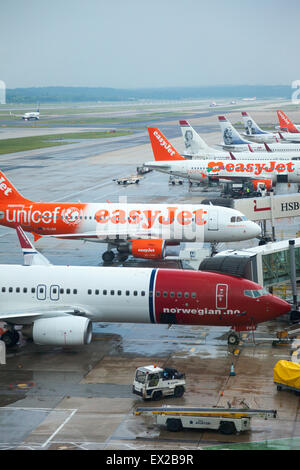 Airplanes lined up on the tarmac at Gatwick Airport, London, England Stock Photo