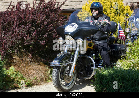 Biker on his Harley Davidson motorcycle Stock Photo