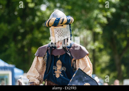 A man dressed as a Knight from the middle ages with an armoured helmet Stock Photo