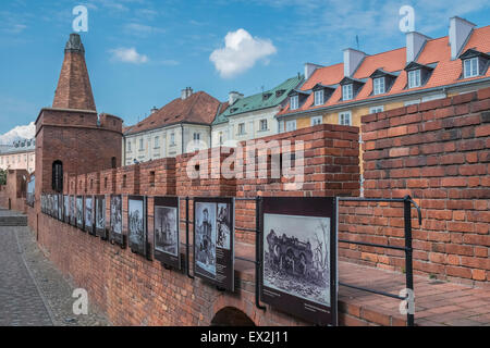 Photographic display of WW2 damage on Old Town walls, and rebuilt modern surroundings Warsaw, Poland Stock Photo