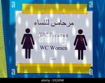 A sign reading 'WC Femmes WC Woman' in Arabic, French and English language is attached to the door of a mobile toilet on the frigate 'Schleswig-Holstein' in Catania, Italy, 04 July 2015. Photo: Soeren Stache/dpa Stock Photo