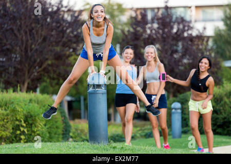Outdoor portrait of running girls having fun in the park. Stock Photo