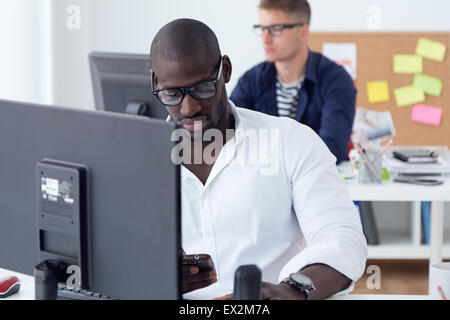 Portrait of young beautiful men working in the office. Stock Photo