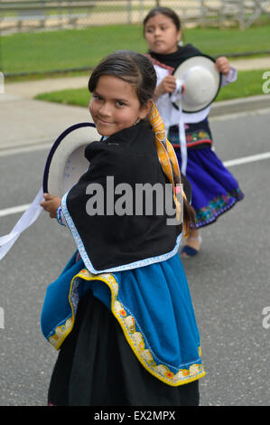 Wantagh, New York, USA. 4th July 2015. A young girl wearing a traditional blue and white dress and black shawl dances with The Ecuadorian Community marchers in the Wantagh Independence Day Parade, a long-time July 4th tradition on Long Island. Credit:  Ann E Parry/Alamy Live News Stock Photo