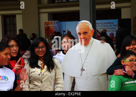 La Paz, Bolivia, 5th July 2015. College students pose for a photo with a life size cardboard cutout of Pope Francis at an event to celebrate his forthcoming visit to Bolivia. Pope Francis will visit La Paz on 8th July during his 3 day trip to Bolivia. Stock Photo