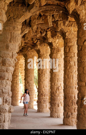 A tourist under the arches in Park Guell ( Parc Guell ) , designed by Antoni Gaudi, Barcelona, Spain Europe Stock Photo