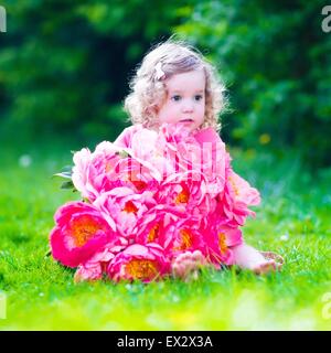 https://l450v.alamy.com/450v/ex2x3a/little-cute-girl-with-peony-flowers-child-wearing-a-pink-dress-playing-ex2x3a.jpg