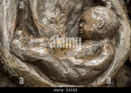 Detail of a sculpture, showing a baby asleep in his mother's arms, in Oudewater, province of Utrecht, The Netherlands. Stock Photo