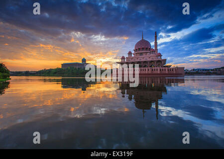 A burning sky cloud during sunrise at Putra Mosque, Putrajaya Malaysia with reflection at the lake surface Stock Photo